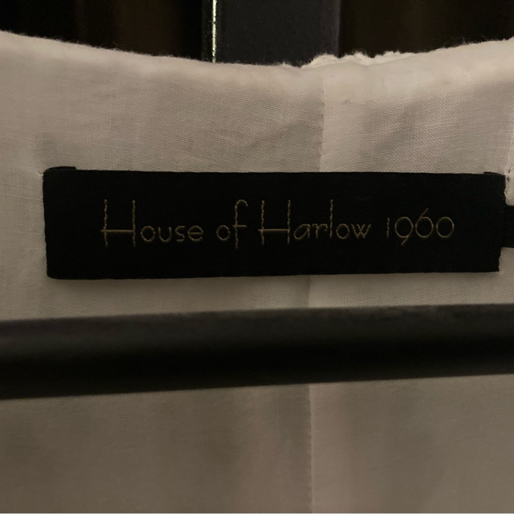 Nicole Richie’s House of Harlow white lined mini dress with “butterfly” sleeves.
